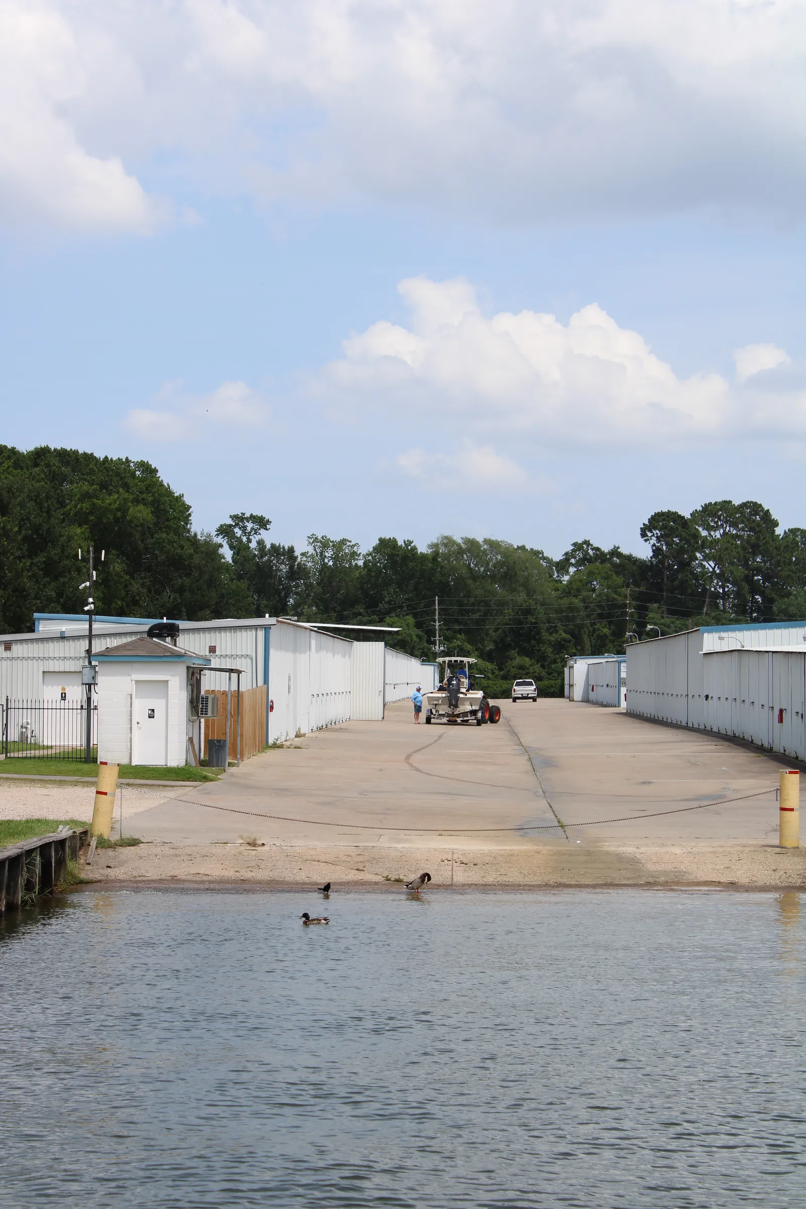 Storage aisle with a valet tractor and launch ramp beyond